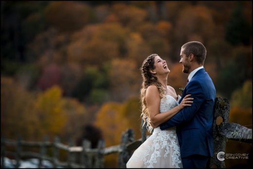 Couple taking photos during their fall wedding in Pittsfield, VT at Riverside Farm Venue