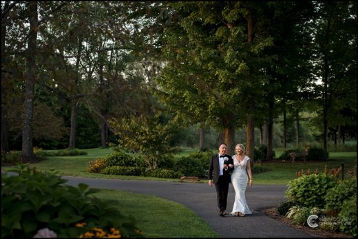 Couple takes outdoor wedding photos on the property of Turning Stone Casino in Verona, NY