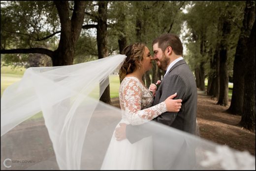 Couple taking outdoor wedding pictures